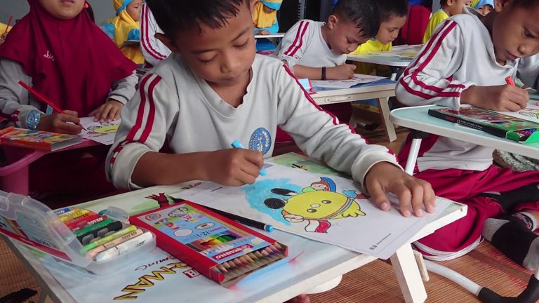 A group of students coloring Coco on paper